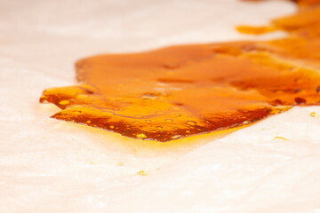 a pieces of cannabis wax closeup. concentrate dab stone with high thc