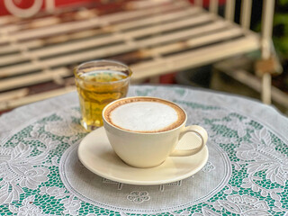 cup of coffee with milk and a glass of water
