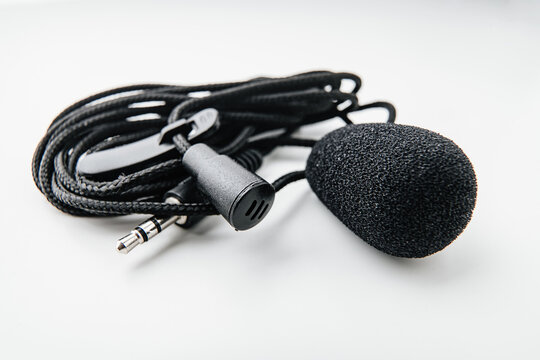 Buttonhole on a white background. Compact microphone for audio recording.