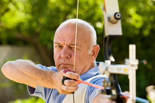 Man Using Bow and Arrow