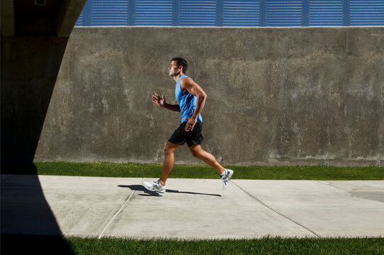 Man Running on Sidewalk