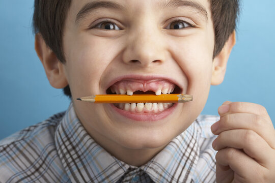 Portrait of Boy With Missing Teeth, Biting Pencil