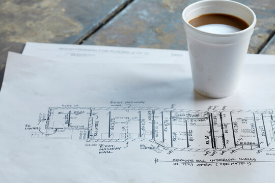 Home Renovation Still Life with Blueprint and Styrofoam Coffee Cup