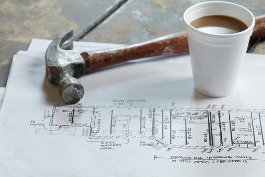 Home Renovation Still Life with Hammer, Blueprint and Styrofoam Coffee Cup