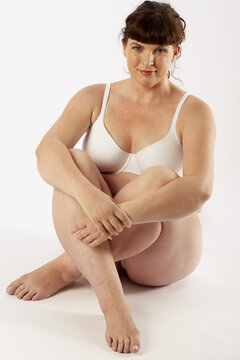 Portrait of Woman Sitting on Floor in Underwear
