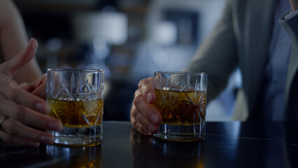 Newlyweds couple hands drinking whiskey closeup. Unknown spouses dating
