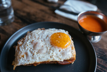 Toast with cheese and sausage covered with fried egg