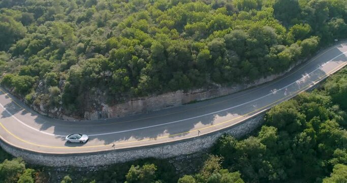 Aerial view of a sport car driving in a woodland, Carmel Forest, Haifa, Israel