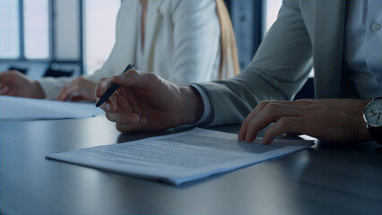 Hand holding pen checking document closeup. Employee reading contract details