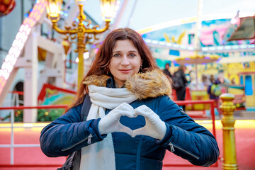 Happy woman on the background of street Christmas lights, Happy New Year, Merry Christmas, winter holiday, eve, walk through the city decorated with lights.