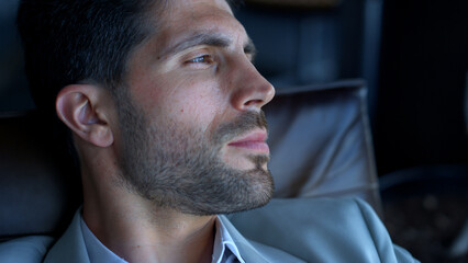 Fototapeta premium Young businessman looking distance closeup. Leader spending vacation alone