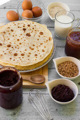 Stack of freshly prepared traditional pancakes with ingredients