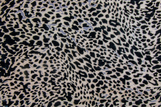 Background with leopard texture, close up. Leopard dyed fabric.
