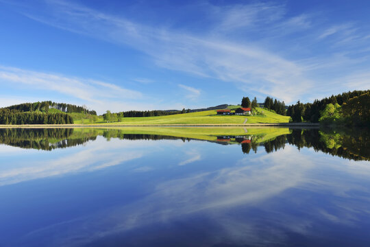 Landscape and Sky Reflecting in Lake, Sameister Weiher, Rosshaupten, Bavaria, Germany