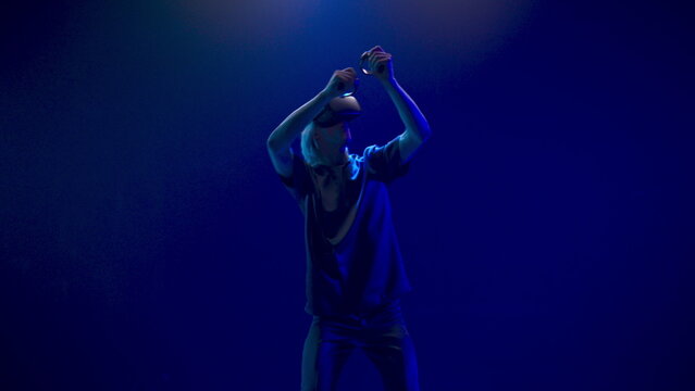 Blonde man playing virtual world game. Metaverse 3d modern technology concept