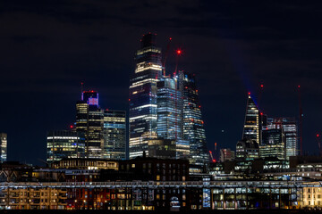 Beautiful view of the city of London by night, glittering skyscrapers across the river Thames