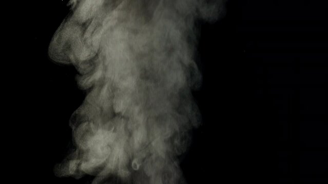 Background slow motion video of smoke from boiling water. Steam rises on a black background. High quality 4k footage
