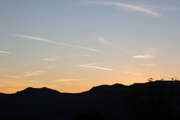 sky streaked by aircraft trails at dusk in the autumn season
