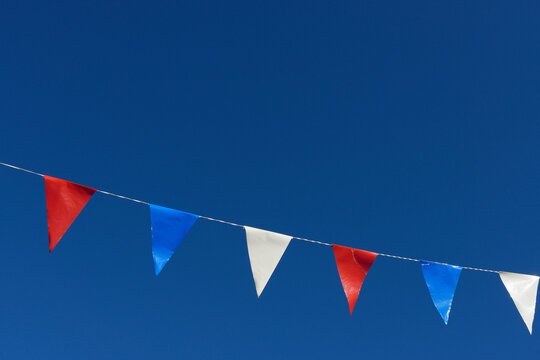 Close-up of pennant flags against blue sky, in the French National Colors, Sault, Provence, Vaucluse, France