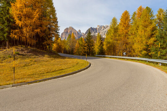 Mountain Road with Larch Trees in Autumn, Passo di Falzarego, Cortina d'Ampezzo, Veneto, Dolomites, Italy