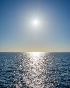 Sun starburst over the North Sea on a sunny day, Netherlands