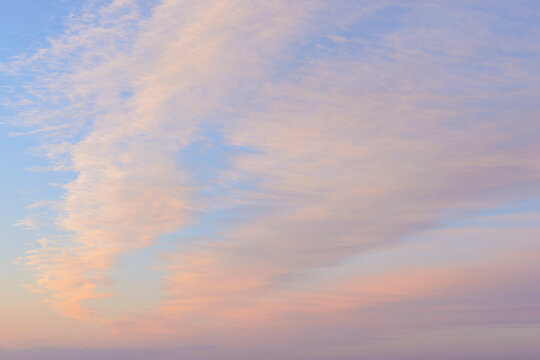 Pastle clouds in the sky at sunrise over Bamburgh in Northumberland, England, United Kingdom