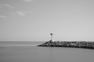A brick white lighthouse in black and white
