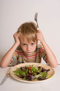 Boy Refusing to Eat Salad