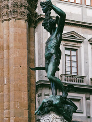 Bronze statue of Perseus holding the head of Medusa in Florence at night, Piazza della Signoria square, made by Benvenuto Cellini in 1545 - 556010144