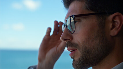 Frustrated man looking window considering business at sea panorama view closeup