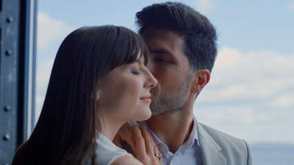 Fototapeta premium Closeup man kissing woman sea view. Happy couple enjoying romantic date
