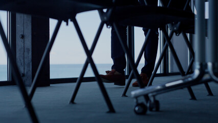 Unknown businessman walking sea view closeup. Man professional legs waiting