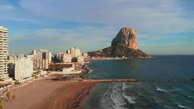 Calpe city with skyscraper buildings by sea and Natural Park of Penon de Ifac