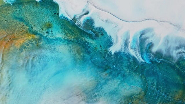 Artistic video painted with liquid acrylic paints. Fluid art for background, wallpapper or theme. Backdrop similar to the landscape of the ocean. Sea artwork with turquoise waves and white foam.
