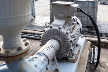 The pump that is adjacent to the electric motor. installed in a chemical factory or oil refinery. Used for sending liquid to various production units of the factory, Concept of industrial works