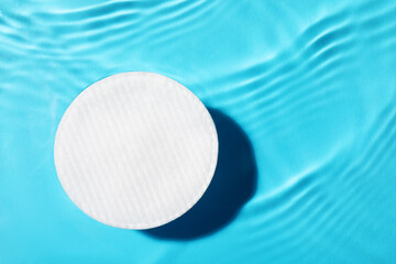Cotton pad and micellar water on light blue background, top view. Space for text © New Africa