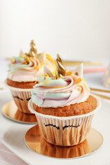 Cute sweet unicorn cupcakes on plate, closeup