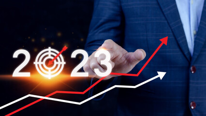 Business target and goal 2023 icon, hand pointing holding 2023 virtual screen and up arrow, Start...