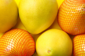 Tasty fresh pomelo fruits on yellow background, top view