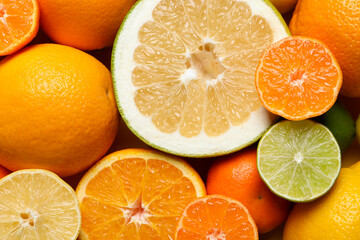 Different ripe citrus fruits as background, top view