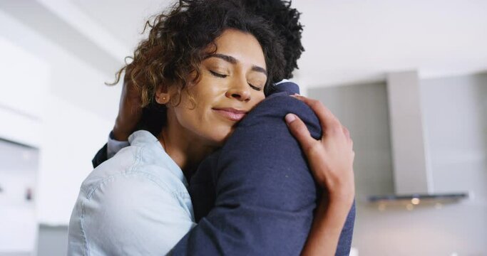 Love, hug and couple on a living room embrace, reunion and excited to be together in their home. Black family, hugging and comfort by black woman holding man in sweet embrace, romance and moment