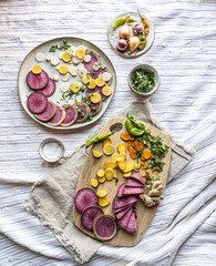 Brightly colored radishes and other fall vetables on a plate - healthy, vegan food ingredients