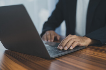 People using computer Side view of male hands typing on laptop keyboard