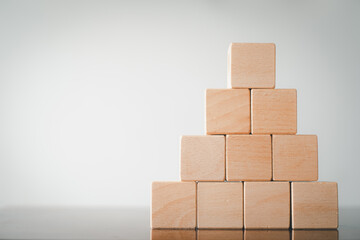 Ten Blank Wooden cubes stack in pyramid shape on right side imange over white background.,Business design,financial,education,abstract,logo,text concept.