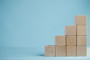 Banner,wallpaper,background,mock up concept.,Ten Blank Clear Wooden cubes for put text or logo stack as stair step shape over blue background use for business,financial,education,growth idea.