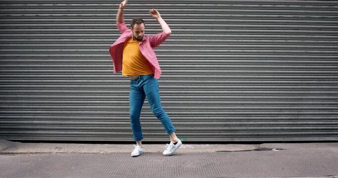 Funny dance of happy man in city with energy, happiness and freedom of movement, groovy music and crazy performance. Excited, meme and comic guy dancing in urban town with action, confidence and joy
