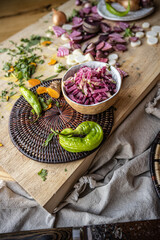 Brightly colored radishes and other fall vetables on a plate - healthy, vegan food ingredients