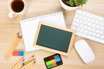 Back to school concept with copy space for flat text, top view, chalkboard mockup on wooden table. Board with school supplies.