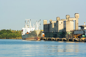 Fototapeta premium cargo ship loading at storage warehouse