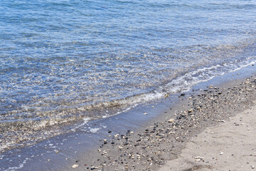 Fototapeta na wymiar Bangsring Beach Banyuwangi, small waves on the beach, wave on the beach, stones on the beach